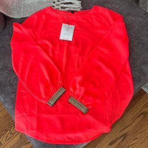 Stella and dot bright orange blouse.